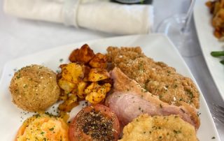 Freshly Breaded Chicken Maryland with Fruit Fritters, Crispy Bacon & Grilled Tomato.
