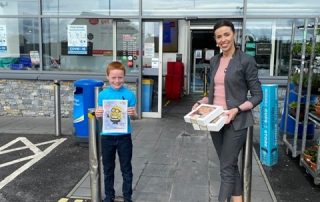 Colouring Competition Winner presented with his prize